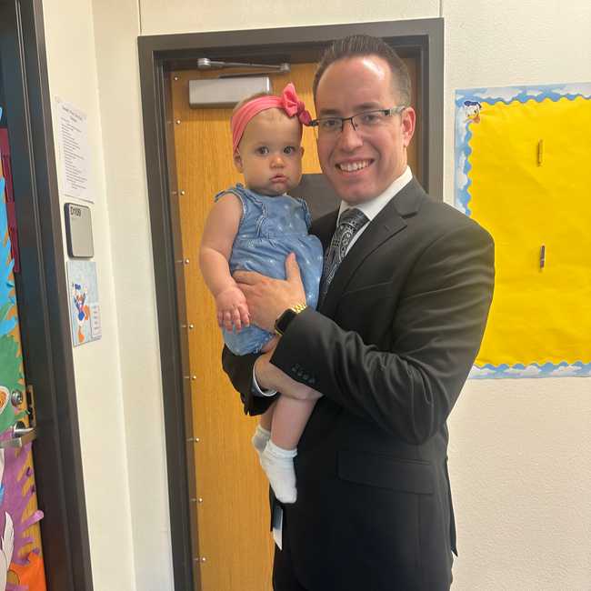 Tate Keen holding his child.